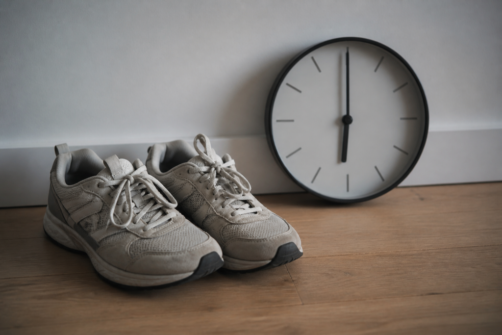 Baskets de sport et montre murale affichant 18 heures